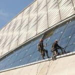 empleados limpiando ventana seguros con afiliacion arl